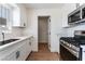 Bright kitchen with white cabinets, stainless steel appliances, and quartz countertops at 1648 J St, Las Vegas, NV 89106