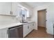 Well-lit kitchen with stainless steel dishwasher and white cabinets at 1648 J St, Las Vegas, NV 89106