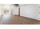 Open-concept living area with wood-look flooring, modern fan, and access to the outdoors at 1648 J St, Las Vegas, NV 89106