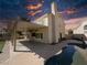 An inviting backyard with a covered patio, a sparkling swimming pool, and meticulous landscaping for serene outdoor living at 2140 Desert Peak Rd, Las Vegas, NV 89134