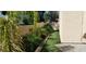 Lush backyard featuring artificial grass and tropical plants, creating a serene outdoor space at 2140 Desert Peak Rd, Las Vegas, NV 89134
