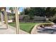 Well-maintained backyard with artificial grass, bocce ball court, and mature landscaping at 2140 Desert Peak Rd, Las Vegas, NV 89134
