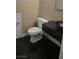 This bathroom features a modern toilet, sleek black floors, and a dark vanity with vessel sink at 2140 Desert Peak Rd, Las Vegas, NV 89134