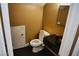 Cozy half-bathroom with dark marble countertop and sleek black tiled floors at 2140 Desert Peak Rd, Las Vegas, NV 89134