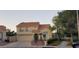 Charming two-story home with a red tile roof, attached garage, and desert landscaping at 2140 Desert Peak Rd, Las Vegas, NV 89134
