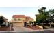 Inviting two-story home showcasing desert landscaping, a red tile roof, and a two-car garage at 2140 Desert Peak Rd, Las Vegas, NV 89134