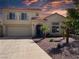 Two story home featuring a red tiled roof, attached two car garage, and a well manicured front yard at 2140 Desert Peak Rd, Las Vegas, NV 89134