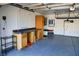 Organized garage interior with workbench and shelving, perfect for storage and projects at 2140 Desert Peak Rd, Las Vegas, NV 89134