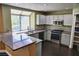 Bright kitchen with modern appliances, granite countertops, tile backsplash, and ample cabinet space at 2140 Desert Peak Rd, Las Vegas, NV 89134