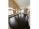 Expansive living room with high ceilings, dark wood floors, and natural light streaming through multiple windows at 2140 Desert Peak Rd, Las Vegas, NV 89134