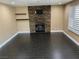 A modern living room featuring dark tile flooring, a stacked stone fireplace, floating shelves, and plantation shutters at 2140 Desert Peak Rd, Las Vegas, NV 89134