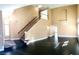 Bright living room with vaulted ceilings, wooden staircase, hardwood floors, and natural light at 2140 Desert Peak Rd, Las Vegas, NV 89134