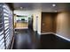 Open living room with hardwood floors, large windows, and a glimpse of the kitchen at 2140 Desert Peak Rd, Las Vegas, NV 89134