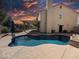 Beautiful backyard pool view, showcasing a private oasis, covered patio, and a neatly landscaped yard at 2140 Desert Peak Rd, Las Vegas, NV 89134