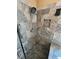 Modern tiled shower with dual shower heads, built in niche and grab bars at 2140 Desert Peak Rd, Las Vegas, NV 89134