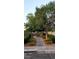 Scenic walking path with mature trees and plants, enhancing the curb appeal at 2140 Desert Peak Rd, Las Vegas, NV 89134