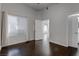 A bedroom with hardwood floors, white trim, large windows, and a door at 2305 W Horizon Ridge Pkwy # 3921, Henderson, NV 89052