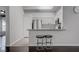 Bright kitchen features white cabinets, stainless steel appliances, granite counters, and two stools at the breakfast bar at 2305 W Horizon Ridge Pkwy # 3921, Henderson, NV 89052