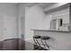 Bright kitchen features white cabinets, stainless steel appliances, granite counters, and two stools at the breakfast bar at 2305 W Horizon Ridge Pkwy # 3921, Henderson, NV 89052