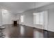 Bright living room with hardwood floors, a modern fireplace, and large windows with sheer white curtains at 2305 W Horizon Ridge Pkwy # 3921, Henderson, NV 89052