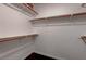 Spacious walk-in closet offering ample storage space with wooden rods and hardwood floors at 2305 W Horizon Ridge Pkwy # 3921, Henderson, NV 89052