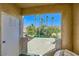 Outdoor patio featuring synthetic grass and a view of tall palms, lawns, and residential houses under a blue sky at 251 S Green Valley Pkwy # 3222, Henderson, NV 89012
