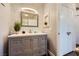 Bathroom featuring gray vanity, stylish mirror, and gray accent wall at 251 S Green Valley Pkwy # 3222, Henderson, NV 89012