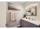 Bathroom featuring a gray vanity, stylish mirror, and decorative tile backsplash at 251 S Green Valley Pkwy # 3222, Henderson, NV 89012