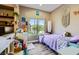 Cozy bedroom featuring a large window, wood floors, and ample decor at 251 S Green Valley Pkwy # 3222, Henderson, NV 89012