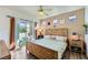 Bright bedroom with wood-look floors, ceiling fan, and sliding glass doors to a small patio at 251 S Green Valley Pkwy # 3222, Henderson, NV 89012