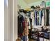 Walk-in closet with rods, shelving, clothes and shoes at 251 S Green Valley Pkwy # 3222, Henderson, NV 89012