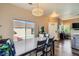 Bright dining room featuring a modern chandelier, wood floors, and a large window with natural light at 251 S Green Valley Pkwy # 3222, Henderson, NV 89012