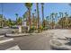 Community entrance at street intersection with palm trees and mature landscaping at 251 S Green Valley Pkwy # 3222, Henderson, NV 89012