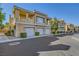 Condo building with garages, lush landscaping, and manicured bushes at 251 S Green Valley Pkwy # 3222, Henderson, NV 89012
