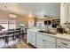 Open floor plan with a kitchen featuring white cabinets, stainless appliances, and a combined dining area at 251 S Green Valley Pkwy # 3222, Henderson, NV 89012