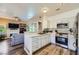 Modern kitchen with stainless steel appliances, white cabinets, a tiled backsplash, and quartz countertops at 251 S Green Valley Pkwy # 3222, Henderson, NV 89012