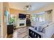 Bright living room features a cozy seating area, wood-look floors, and a modern fireplace with a mounted TV at 251 S Green Valley Pkwy # 3222, Henderson, NV 89012