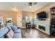 Cozy living room with wood-look floors, a fireplace, TV, and a comfortable sofa, ideal for relaxing at 251 S Green Valley Pkwy # 3222, Henderson, NV 89012