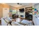 Comfortable living space with wood-look floors, a modern fireplace, a TV, and a stylish gray sofa at 251 S Green Valley Pkwy # 3222, Henderson, NV 89012