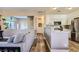 Open concept living room shows seamless flow into kitchen with stainless appliances and modern countertops at 251 S Green Valley Pkwy # 3222, Henderson, NV 89012