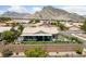 Aerial view of a backyard featuring an outdoor seating area, bar, pergola and a scenic mountain backdrop at 2616 Faiss Dr, Las Vegas, NV 89134
