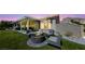 Outdoor patio area with a stylish seating arrangement surrounding a stone fire pit at 2616 Faiss Dr, Las Vegas, NV 89134