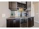 This bar area features a wine fridge, custom cabinetry, and a decorative backsplash at 2616 Faiss Dr, Las Vegas, NV 89134