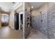 Lavish walk-in shower featuring multiple shower heads and grey tile at 2616 Faiss Dr, Las Vegas, NV 89134