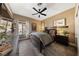Cozy bedroom showcasing a ceiling fan and a large window with natural light at 2616 Faiss Dr, Las Vegas, NV 89134