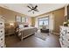 Bright bedroom features a sitting area, a ceiling fan, and large windows at 2616 Faiss Dr, Las Vegas, NV 89134