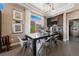Elegant dining area featuring a modern light fixture, wine storage, and access to the outdoor space at 2616 Faiss Dr, Las Vegas, NV 89134