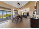 Bright dining area with a large table, stylish pendant lighting, and sliding glass doors with an outdoor view at 2616 Faiss Dr, Las Vegas, NV 89134
