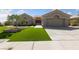 Single-story home showcasing a well-manicured lawn, elegant landscaping, and a spacious two-car garage at 2616 Faiss Dr, Las Vegas, NV 89134