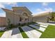 Attractive front yard with concrete driveway strips and low maintenance desert landscaping under a bright, sunny sky at 2616 Faiss Dr, Las Vegas, NV 89134